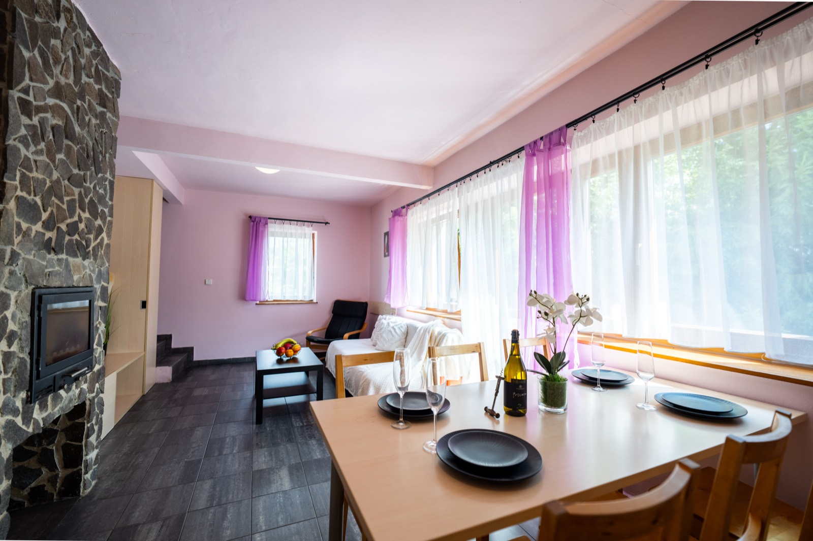 Apartmán Hřeben: prostorný obývací pokoj s kamenným krbem